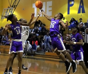 Miller Grove's Jamarcus Glover (25) pulls down one of his 11 rebounds off a missed free throw. He grabbed the ball in front of teammate's Jahmil Barber (14) and Zyair Greene (11) and Southwest DeKalb's Chandler Sanders (12). (Photo by Mark Brock)