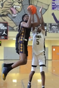 Southwest DeKalb's Kourtney Forrest (with ball) shoots for two of his 19 points against Lithonia's Chase Champion (5). Forrest was named MVP. (Photo by Mark Brock)