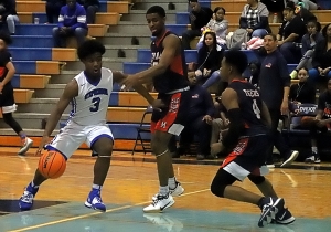 Stephenson's Edwin Walker drives into the lane against a pair Mundy's Mill defenders during Stephenson's win in Region 4-6A play at Lovejoy on Wednesday. (Photo by Mark Brock)
