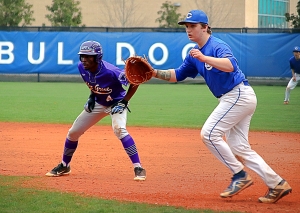 Miller Grove's Jakoby Oliver (4) gets a lead off first as Chamblee first baseman Leon Cohen moves to get in his position on defense. (Photo by Mark Brock)