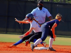 Chamblee's Margaret Axelson (left) beats the tag of Dunwoody shortstop Ryan Boaz (right) to reach second base safely. (Photo by Mark Brock)