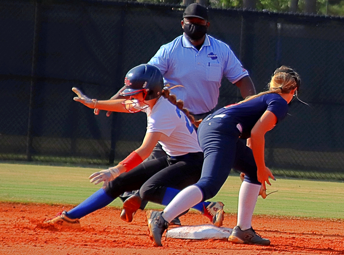 Chamblee's Margaret Axelson (left) beats the tag of Dunwoody shortstop Ryan Boaz (right) to reach second base safely. (Photo by Mark Brock)