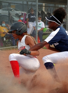 Druid Hills' Erielle Reid beats the tag of Arabia Mountain's Ashley Brown to score one of her three runs in the Red Devilsl' 8-1 Region 6-4A victory on Thursday. (Photo by Mark Brock)
