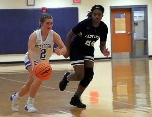 Chamblee's Savannah Russell (2) dribbles up court against Martin Luther King's Jana Berry during King's 49-28 Region 5-5A victory. (Photo by Mark Brock)