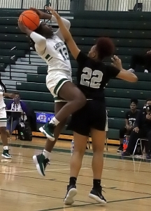 Arabia Mountain's Makayla Jamison (12) goes up for a basket against Miller Grove's Trinity Coleman (22) in the Lady Rams win to stay undefeated. (Photo by Mark Brock)