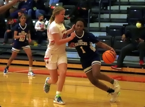 Redan's Carmen Cooper (1) drives the baseline against GAC's Molly Pritchard (00) during second half action of GAC's 81-41 Region 5-3A girls' semifinal win. (Photo by Mark Brock)