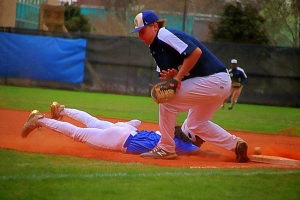 Chamblee's Sydyk Ross dives safely back into first base as Decatur first baseman James White tries to come up with a low throw on a pick-off attempt. Decatur won the Region 5-5A game 11-3. (Photo by Mark Brock)