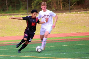 Druid Hills Dani Bibiano (10) maneuvers against Benedictine's Nick Dillon during first half action of the Red Devils 2-0 upset of the 10th ranked Cadets. (Photo by Mark Brock)