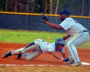 Martin Luther King's Leigh Allen dives safely back to first as Lithonia first baseman Wesley Covert waits for a throw during the Lions 11-4 win at Lithonia. (Photo by Mark Brock