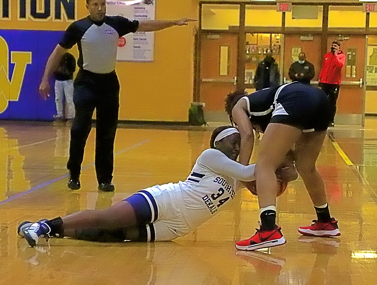 Southwest DeKalb's Aniyah Lee (34) battles a Woodward player for a loose ball during first half action of Woodward's Class 5A Elite Eight state playoff win. (Photo by Mark Brock)