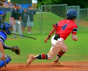 Dunwoody's Nathan Pettitt (4) heads to first base on a hit into left field during the Wildcats' playoff loss to South Forsyth. (Photo by Mark Brock)