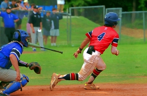 Dunwoody's Nathan Pettitt (4) heads to first base on a hit into left field during the Wildcats' playoff loss to South Forsyth. (Photo by Mark Brock)