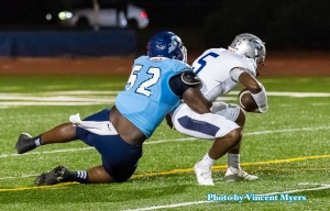 Cedar Grove Preseason All-State defensive lineman Christian Miller (52) sacks Redan's Antoine Hector (5) in the Saints win last week. Miller and his Cedar Grove teammates travel to take on No. 7 ranked Lowndes on Friday. (Photo by Vincent Myers)