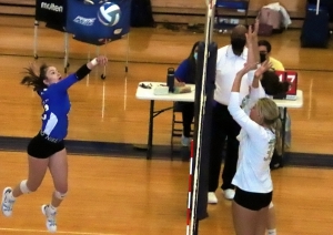 Chamblee's Anna Birukuva (left) hits a shot back over Calhoun blockers at the net during the Bulldogs 3-0 win in the first round of the Class 5A volleyball state playoffs at Chamblee. (Photo by Mark Brock)