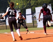 Chamblee's Rachel Axelson (75) makes a throw to Savannah Russell (center) to get Coffee runner Saniya Hill (8) out at first during Chamblee's opening game win in the two teams Class 5A best-of-three series. (Photo by Mark Brock)