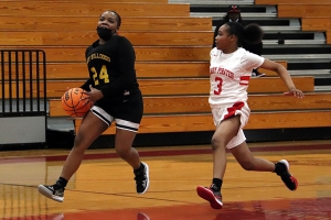 Lithonia's Janiya Smith (24) drives to the basket on her way to a game-high 26 points in Lithonia's thrilling 53-52 last second win over Stone Mountain in Region 5-5A girls' action at Stone Mountain on Tuesday. (Photo by Mark Brock)