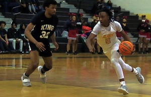 Lithonia's Chase Champion (5) drives the lane against Martin Luther King's Chancellor Harris (32) during Lithonia's 60-32 Region 5-5A win on Tuesday night. (Photo by Mark Brock)