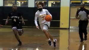 Martin Luther King Jr.'s Kaya Jarvis (4) chases Lithonia's Asis Freeman (3) as they head up court. Freeman finished with  a game-high 23 points to lead her team to a 43-38 win. (Photo by Mark Brock)