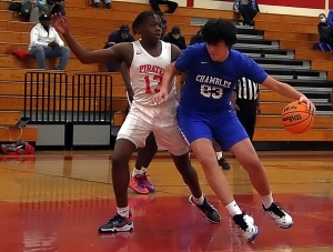 Stone Mountain's Tory Spratt (13) defends in the lane against Chamblee's Eli Star (23). Chamblee won the Region 5-5A matchup 66-57 at Stone Mountain. (Photo by Mark Brock)