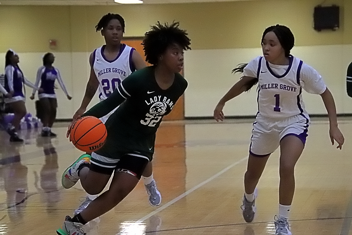Arabia Mountain's Sierra Burns (32) gets to the baseline past Miller Grove's Antoinette Mountain (1). Burns had 16 points and 7 rebounds in the Lady Rams 65-33 Region 4-6A win on Tuesday at Miller Grove. (Photo by Mark Brock)