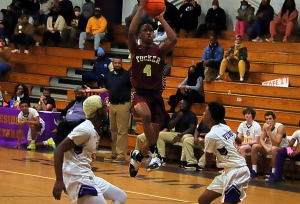 Lakeside's Treshon Powell (20) and AJ Wheeler (21) try to head off Tucker's Christorpher Whitmore as he drives the lane for a basket in Tucker's 75-48 Region 4-6A boys' basketball win at Lakeside on Friday night. (Photo by Mark Brock)