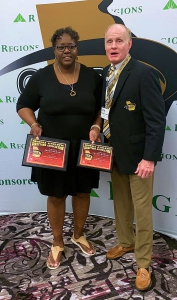 Arabia Mountain High School Athletic Director Sharon Richard (left) receives her Region 6-4A and Class 4A AD of the Year Awards from GADA representative Tommy Marshall. 