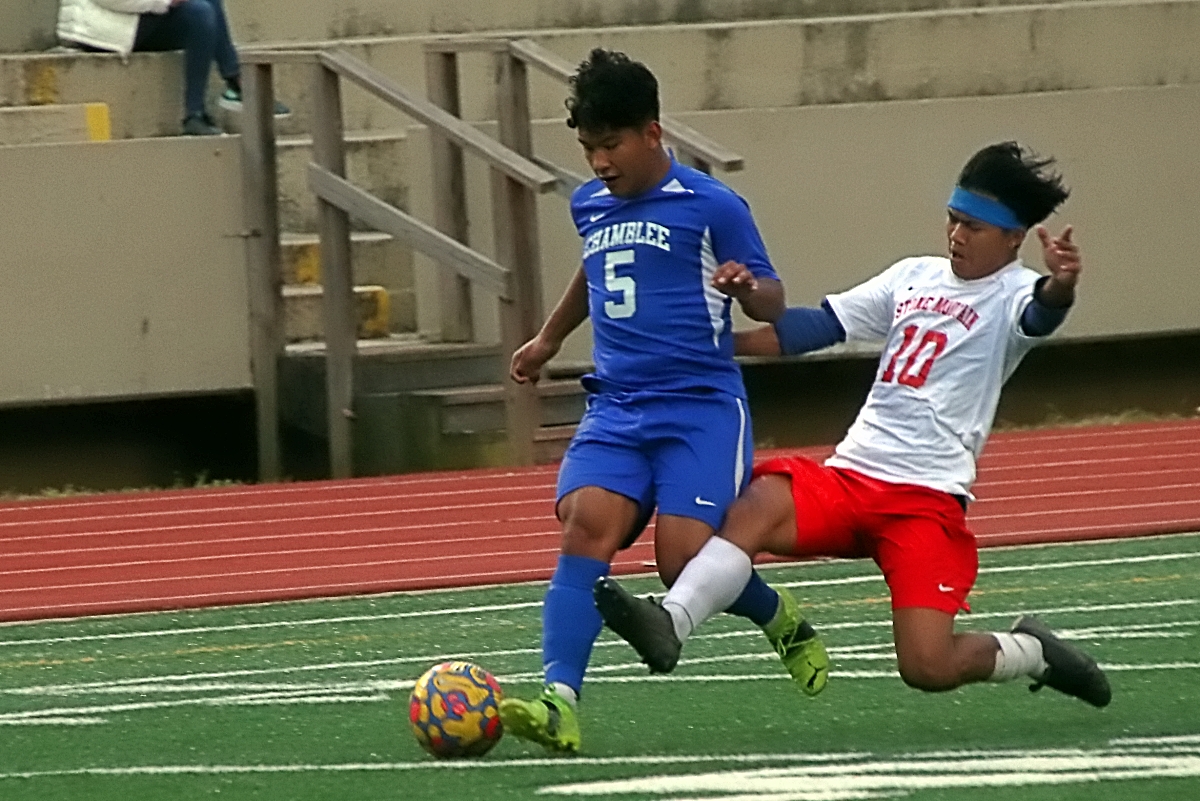 Chamblee's Angel Sabino (5) tries to avoid Stone Mountain's Nam Kua Aung (10) during first half action of Chamblee's 3-0 Region 5-5A victory over Stone Mountain on Tuesday. (Photo by Mark Brock)