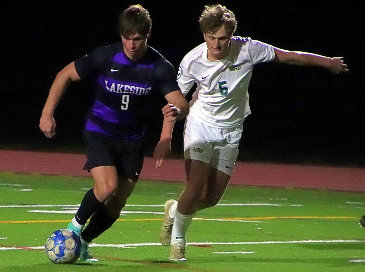 Lakeside's Zach Martin (9) slips past a Holy Spirit Prep defender on the way to one of his two second half goals in the Vikings 4-0 win. (Photo by Mark Brock)