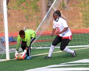 Stone Mountain goalkeeper Manish Kaykez (left) makes one of her six saves in the first half against No. 3 ranked Chamblee. Defensive teammate Maimuna Tamba (21) comes over to help defend. (Photo by Mark Brock)