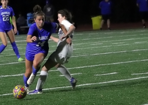 Chamblee's Sarah Washburn (14) maneuvers around a Woodland defender during Chamblee's 10-0 Class 5A first round state playoffs victory on Tuesday. (Photo by Mark Brock)