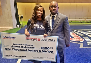 Lithonia's Armania Holloway (left) received a $1,000 Academy Sports + Outdoors Positive Athlete Scholarship during a recent ceremony at the Chick-Fil-A College Football Hall of Fame. Pictured with her is DCSD Athletics Middle School Coordinator Paris Burd (right).