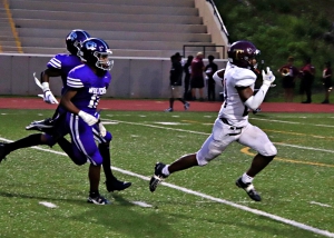 Tucker junior running back Jordan McCoy (right) out races a pair of Miller Grove defenders to the end zone for one of his four scores on the night in Tucker's 45-14 win at Hallford Stadium. (Photo by Mark Brock)
