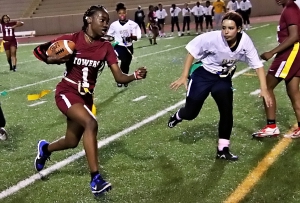 Towers Macada McDonald (1) runs past Elite Scholars' defender Tyler Brown (5) for one of her two touchdowns on the night in Towers 20-0 win. (Photo by Mark Brock)