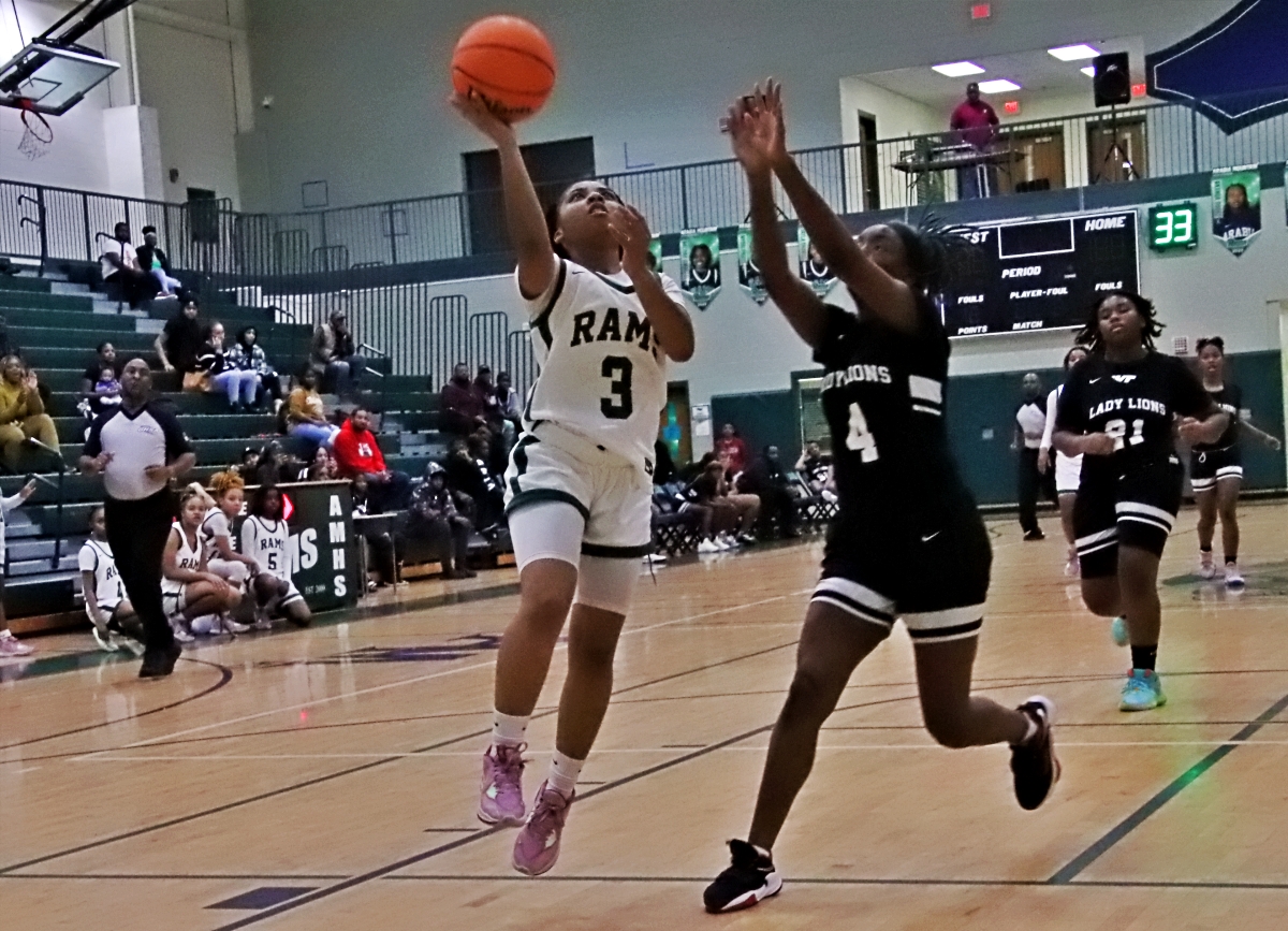Arabia Mountain's Jayla Thomas (3) goes in for a layup on a fastbreak against Martin Luther King's Amelia Stewart (4) during Arabia's 91-11 win. (Photo by Mark Brock)