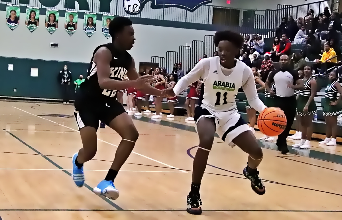 Martin Luther King's RJ Norwood (left) defends against Arabia Mountain's Korey Gribble (11) during Arabia Mountain's 62-54 win on Friday night. (Photo by Mark Brock)