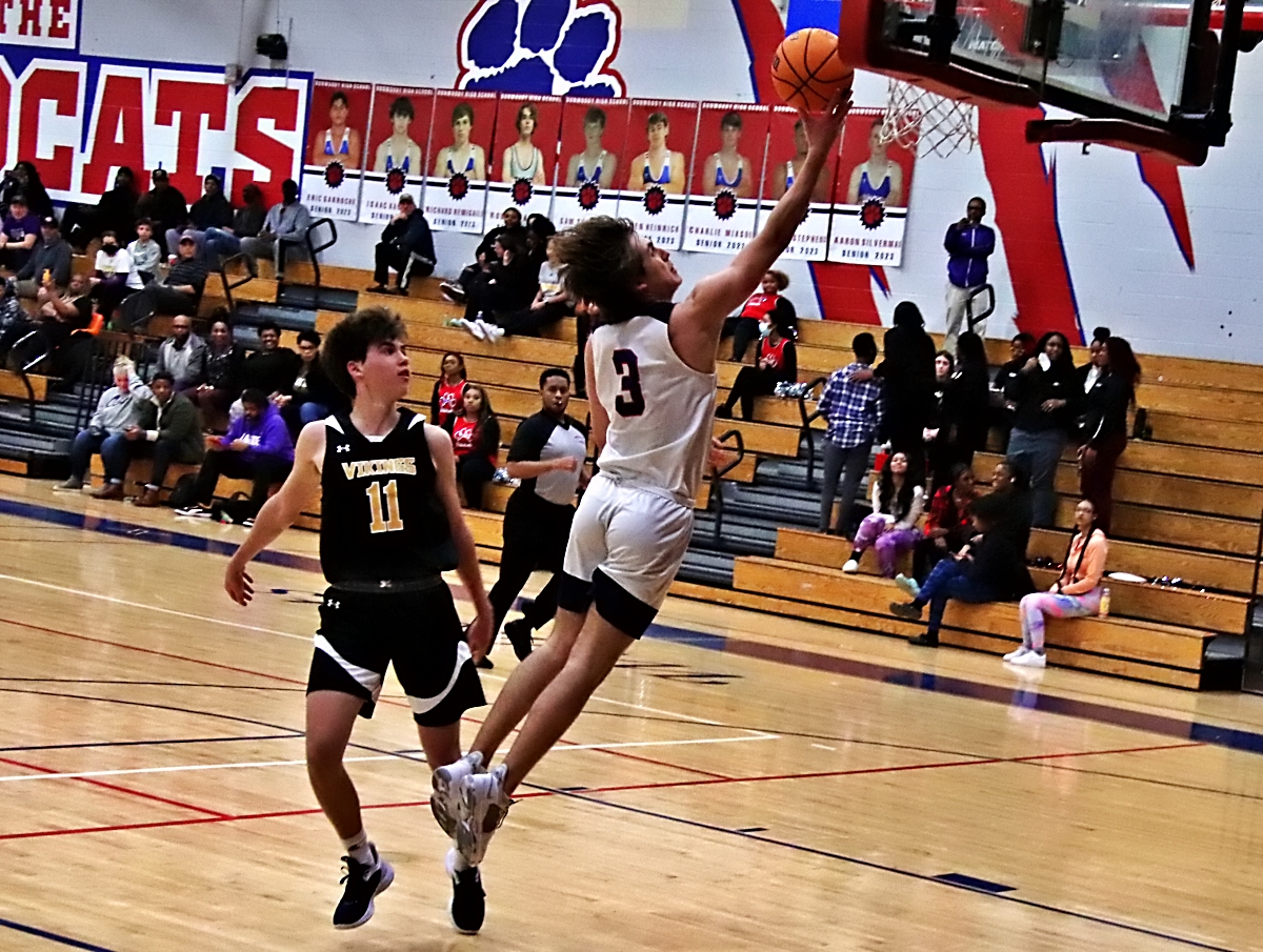 Dunwoody's Ryan Smith (3) lays the ball up on a fast break against Lakeside's Sam Sharro (11). Smith keyed a big third quarter for Dunwoody in the 70-54 win. (Photo by Mark Brock)