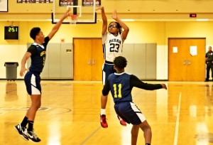 Redan's Tristan Mitchell (23) hits a big three-pointer against Chapel Hill's Nazir Mergan and Derrick Brown. Mitchell had 26 points and 8 rebounds to be named the game's MVP. (Photo by Jermaine Walker)