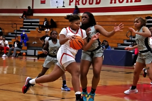 Stone Mountain's Nyla Warren (33) drives inside against Hapeville's Ava Freeman (23) during Stone Mountain's Region 6-4A loss to Hapeville. (Photo by Mark Brock)