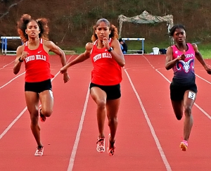 Druid Hills Sanaa Frederick (center) on the way to second her new meet record of 23.45 in the 200-meter dash. Chasing her are sister Sole Frederick (left) and 400-meter record setter Davenae Fagan of Arabia Mountain. (Photo by Mark Brock)
