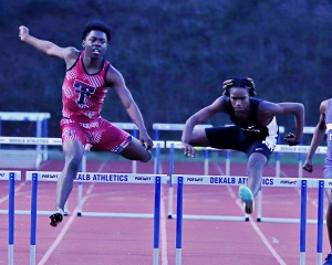 Redan's Nizer Smith (right) on the way to a win in the 300-meter hurdles against Towers' Jerkarean West (left). It was one of three gold medals for the Raider track star. (Photo by Mark Brock)