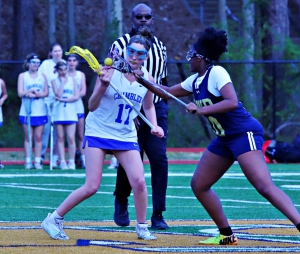 Chamblee's Ashley Nelson (17) and Southwest DeKalb's Toni Bryant (10) battle for a face-off during Chamblee's 23-4 win in girls' lacrosse at Southwest DeKalb on Tuesday. (Photo by Mark Brock)