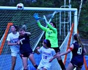 Lakeside's Isabella La Madrid (in green) goes up in a crowd to make a save off a Dunwoody corner kick. She had seven saves as the Lady Vikings knocked off Dunwoody 3-0 to reach the state playoffs. (Photo by Mark Brock)