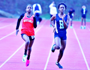 McNair's Rhimani Duffie (left) was the meet's fastest girl as she captured both the 100- and 200-meter dashes. Henderson's Adara Davis (right) was second and third in the two races. (Photo by Mark Brock)
