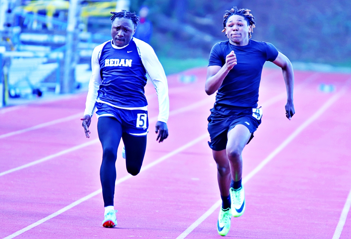 Stephenson's Jordan Christie (right) finished as DCSD's middle school track's fastest man with his sweep of the 100-and 200-meter dashes. Redan's Jeremiah Parker (left) finished second behind Christie in both races. (Photo by Mark Brock)