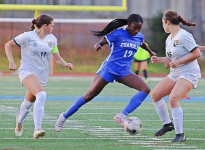 Chamblee's Kara Croone (17) weaves past Ola defenders Payton Bates (11) and Brooklyn Veliz (26) on the way to the first of her four goals in the first four minutes of the second half of Chamblee's 10-0 Class 5A girls' Sweet 16 state playoff game. (Photo by Mark Brock)