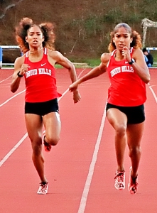 Druid Hills twins Sole Frederick (left) and Sanaa Frederick (right) put on a show in the 200-meter dash state prelims and finals with back-to-back records. (Photo by Mark Brock)