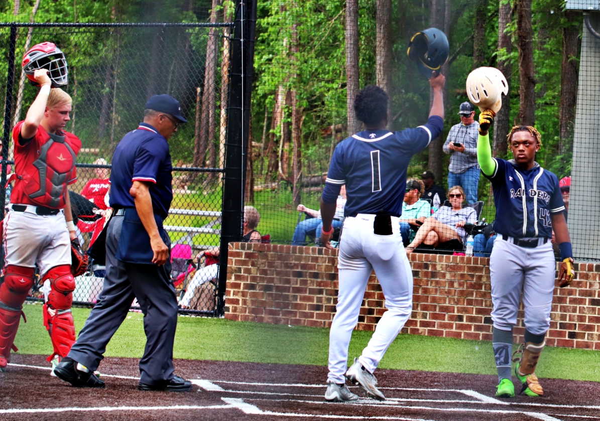 Redan's Bernard Moon (1) celebrates his solo homer with Tyrell Wyatt after putting the Raiders up 1-0. (Photo by Mark Brock)