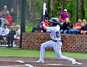 Redan's Luis De La Cruz strokes a run-scoring double during Redan's state playoff quarterfinal 7-0 victory. De La Cruz went 3-3 with two doubles and three RBI in the game and then pitched two perfect innings of relief in the game 2 loss. (Photo by Mark Brock)