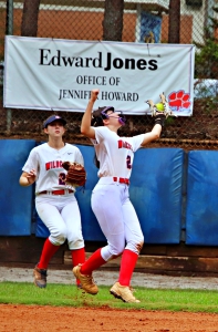Dunwoody second baseman Sienna Rembelos drifts into shallow right field to catch a fly ball as right fielder Allie Sleep backs up on the play against Walton. (Photo by Mark Brock)