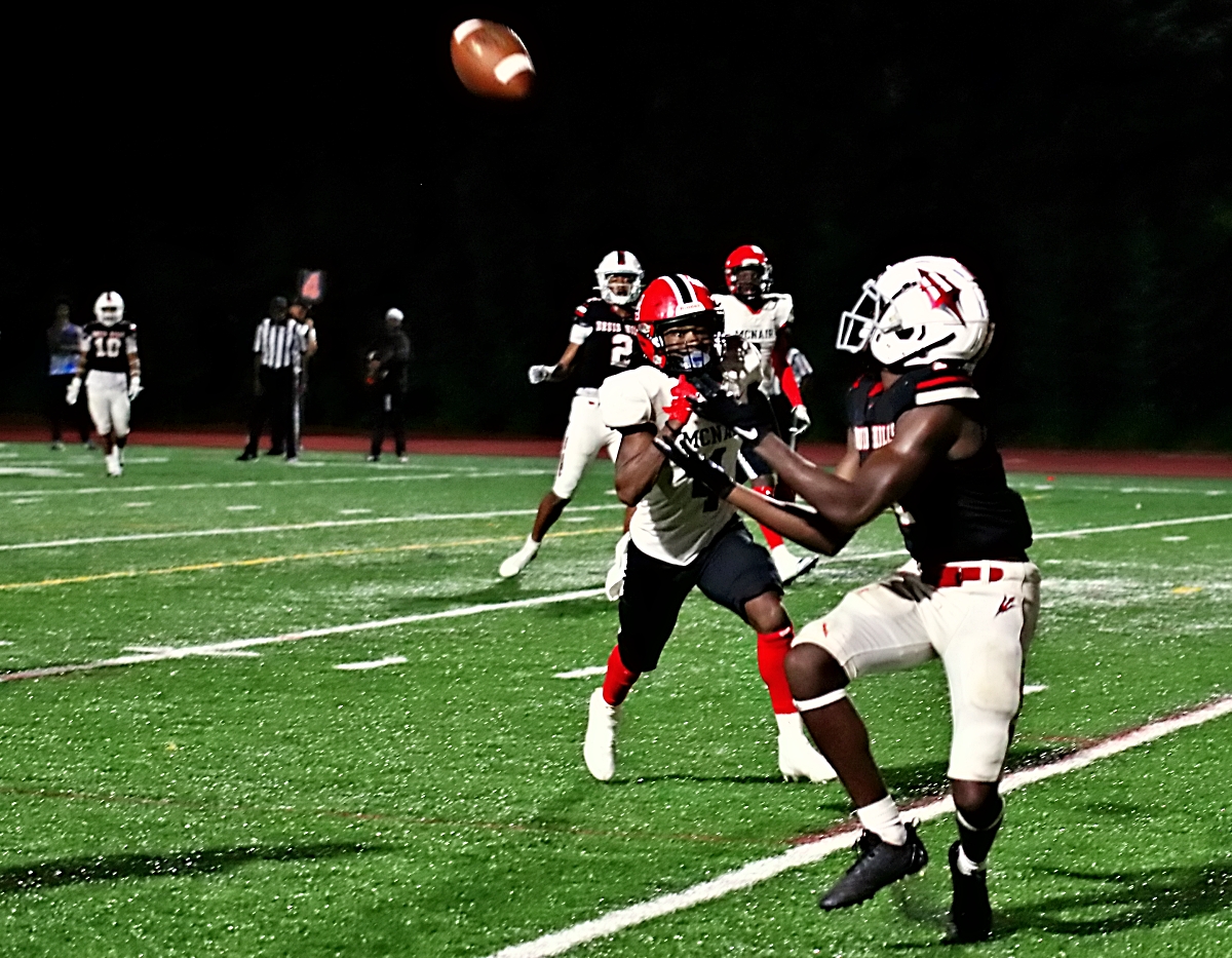 Druid Hills' Reese Patterson hauls in a 20-yard touchdown pass from Kai Robinson on a fourth and 16 play to get the Red Devils' rally started in their 27-18 win over McNair. (Photo by Mark Brock)